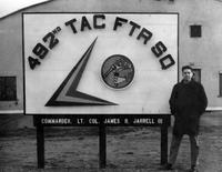 Captain Roy J. Blakeley standing next to sign: 492nd Tactical Fighter Squadron, 48th Tactical Fighter Wing, Lakenheath Air Force Base, Suffolk, England, United Kingdom (January 1960)