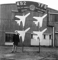 Captain Roy J. Blakeley standing next to sign: 492nd Tactical Fighter Squadron, 48th Tactical Fighter Wing, Lakenheath Air Force Base, Suffolk, England, United Kingdom (January 1960)