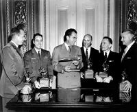 Recipients of the 1958 Robert J. Collier Trophy standing with Vice President, Richard M. Nixon (center) holding a model of a Lockheed F-104 Starfighter (left to right): Captain Walter W. Irwin; Major Howard C. Johnson; Neil Burgess; Gerhard Neumann; and Clarence Leonard "Kelly" Johnson.