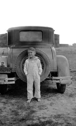 Roy J. Blakeley (circa 1935; 6 years old): Barefoot on oil field road in East Texas.