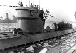 German type IX submarine docking at Tromso, Norway, during World War II. Note ship's insignia, and ice flows.  Source: Catalog #: NH 71374; Naval History and Heritage Command; U.S. Navy