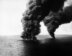 Dixie Arrow tanker burning after being hit on the starboard side by two torpedoes fired from German U-boat U-71; Location: Cape Hatteras (off the coast of North Carolina); March 26, 1942. Source: National Archives.