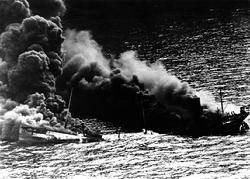 Dixie Arrow tanker burning after being hit on the starboard side by two torpedoes fired from German U-boat U-71; Location: Cape Hatteras (off the coast of North Carolina); March 26, 1942. Source: National Archives.
